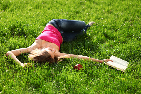 2129911-20789-woman-reading-book-in-the-park-on-the-grass